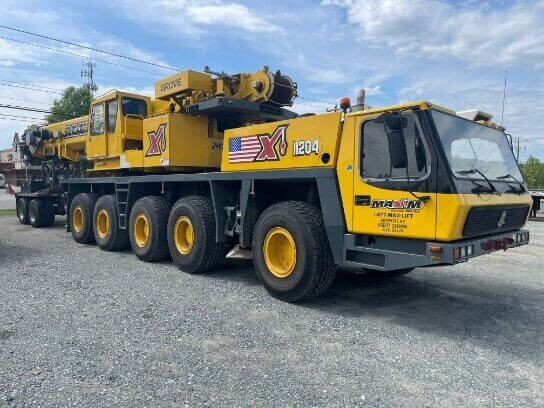 Grove EX1204 crane parked, showcasing heavy-duty construction equipment for lifting and transport.