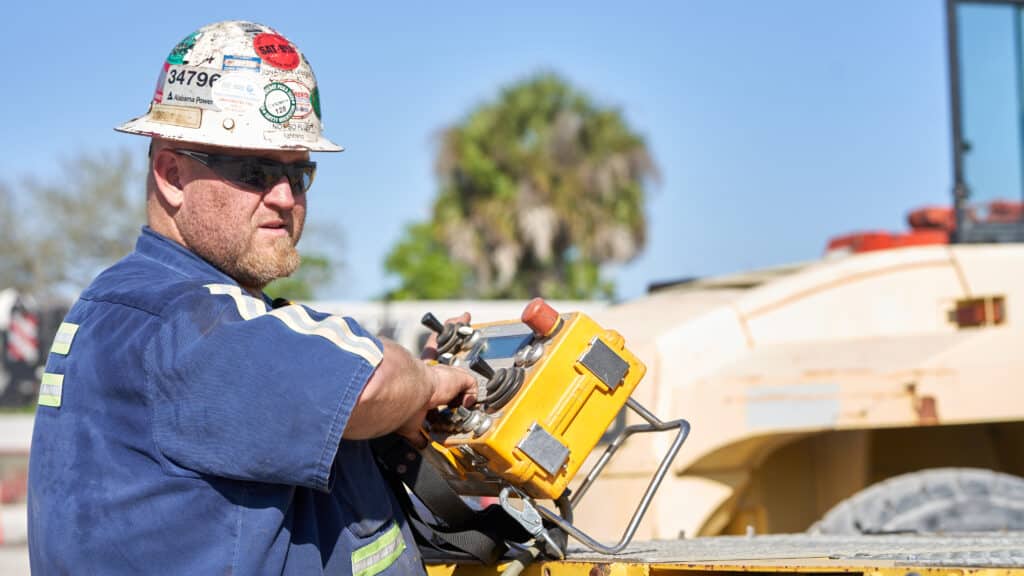 A man operating a lifting crane