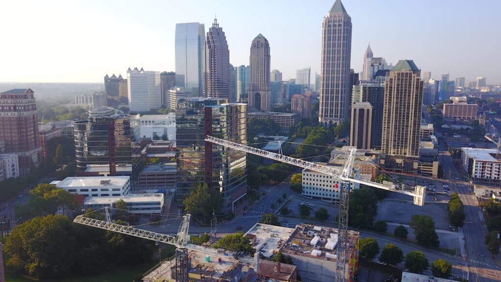 crane terminology concept with tower cranes in the foreground of a city skyline