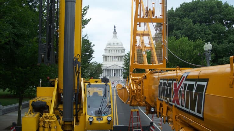 infrastructure projects with cranes concept with civil building in background and Maxim crane in foreground