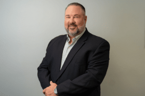 Confident man in a suit posing for a professional portrait.