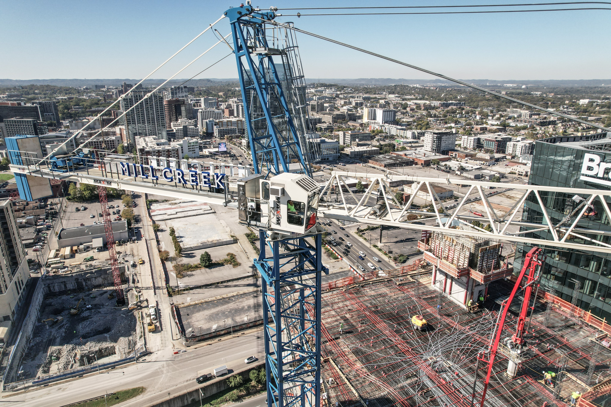 Construction crane overlooking Mill Creek area with cityscape in the background.