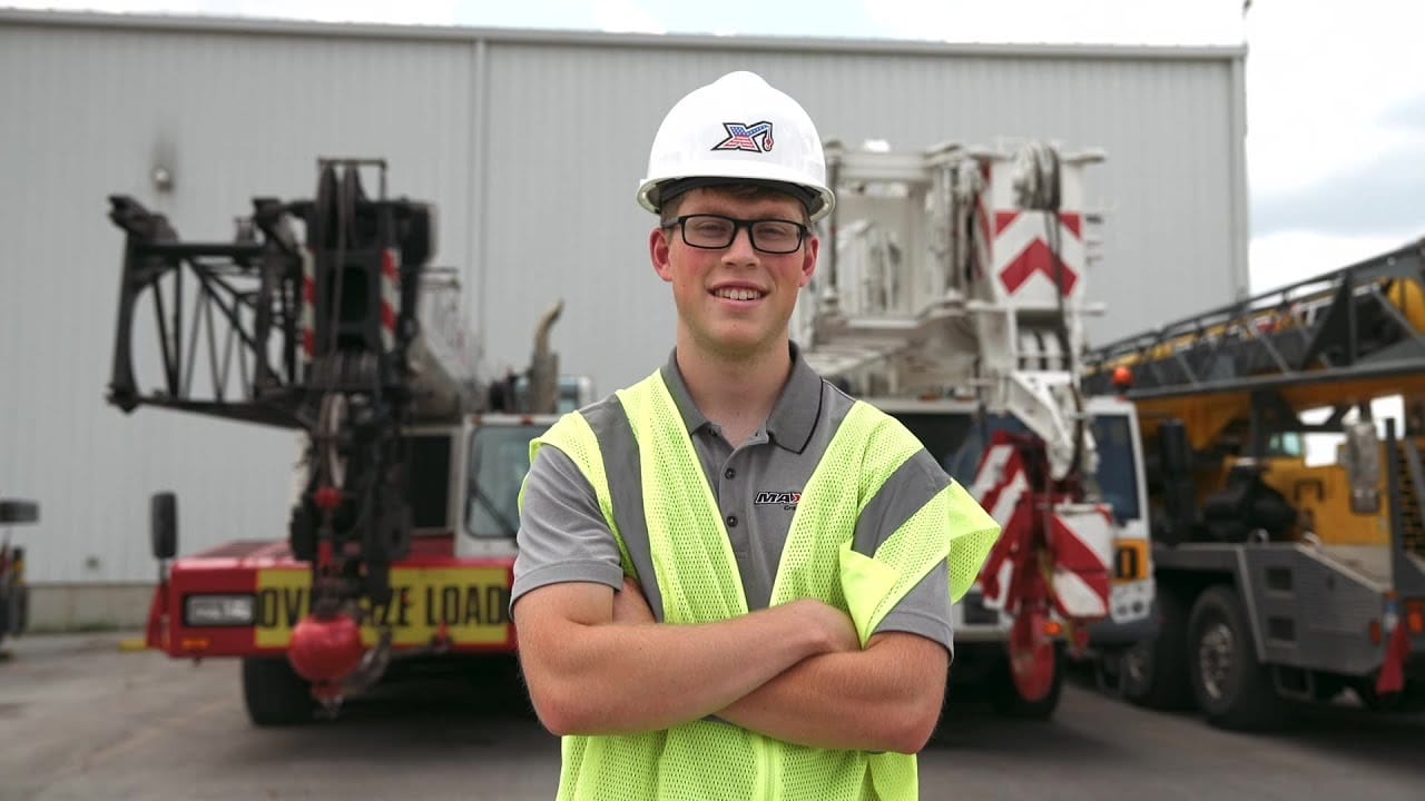 Enginneering Intern, Ian wearing a safety vest and hard hat.