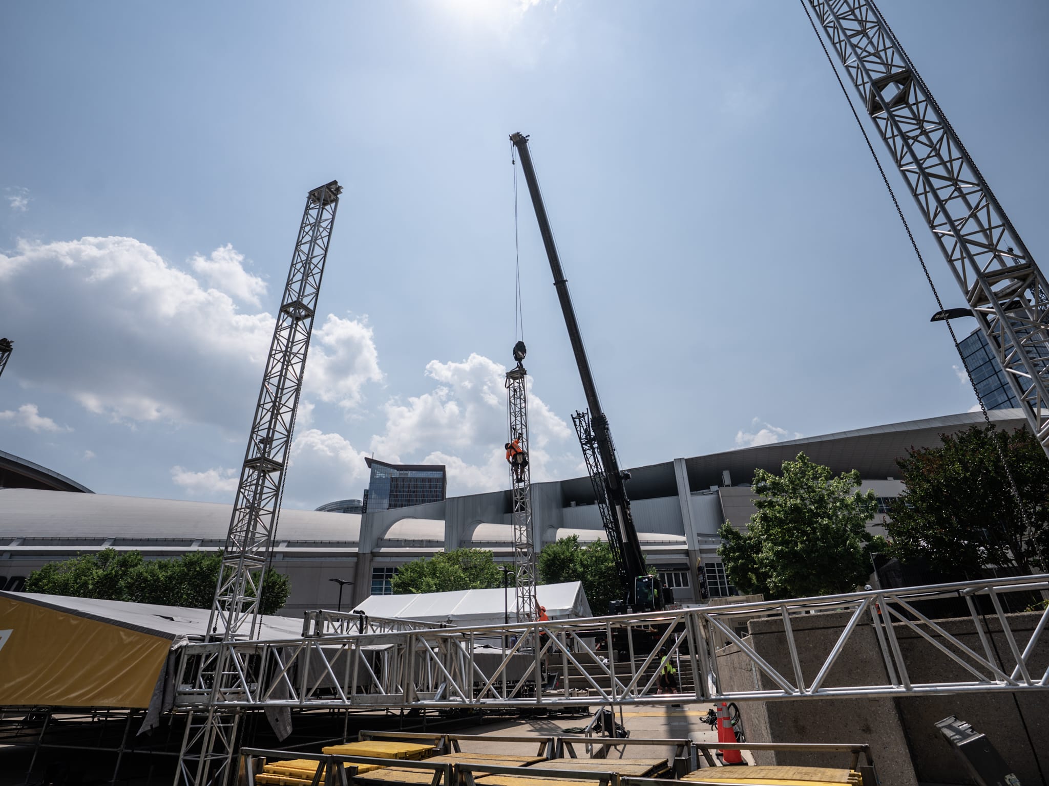 Crane setup at the 2025 CMA Fest in Nashville, TN with workers and equipment under a clear sky.
