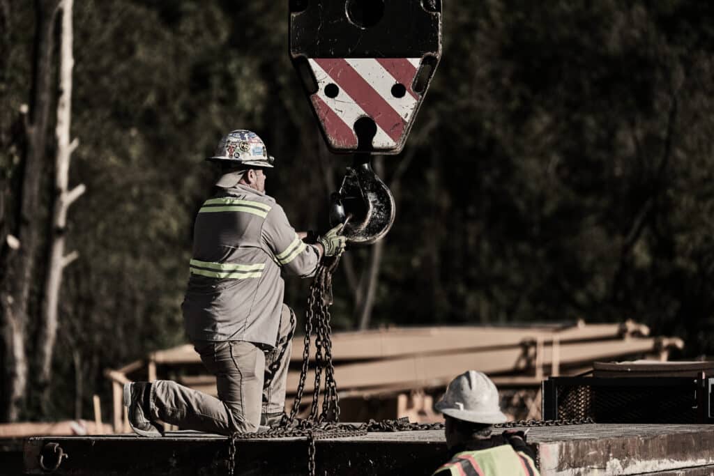 Crane operator skillfully managing loads with a focus on safety at the construction site.