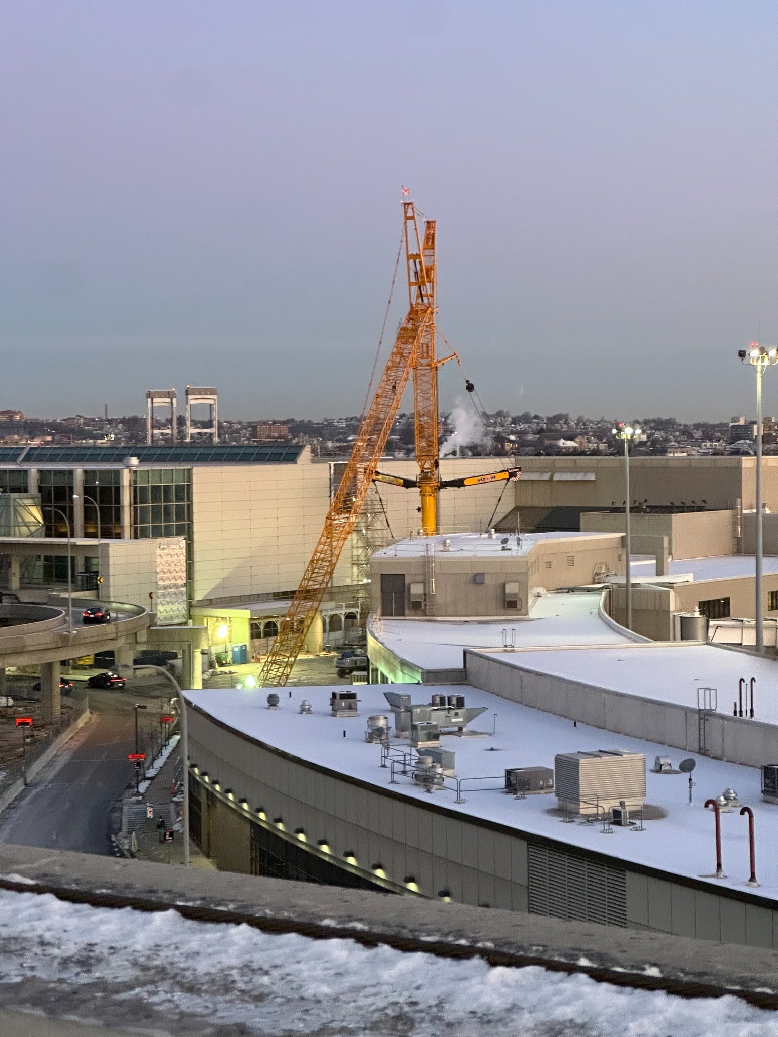 Construction crane at Boston Logan Airport, highlighting urban development and progress.