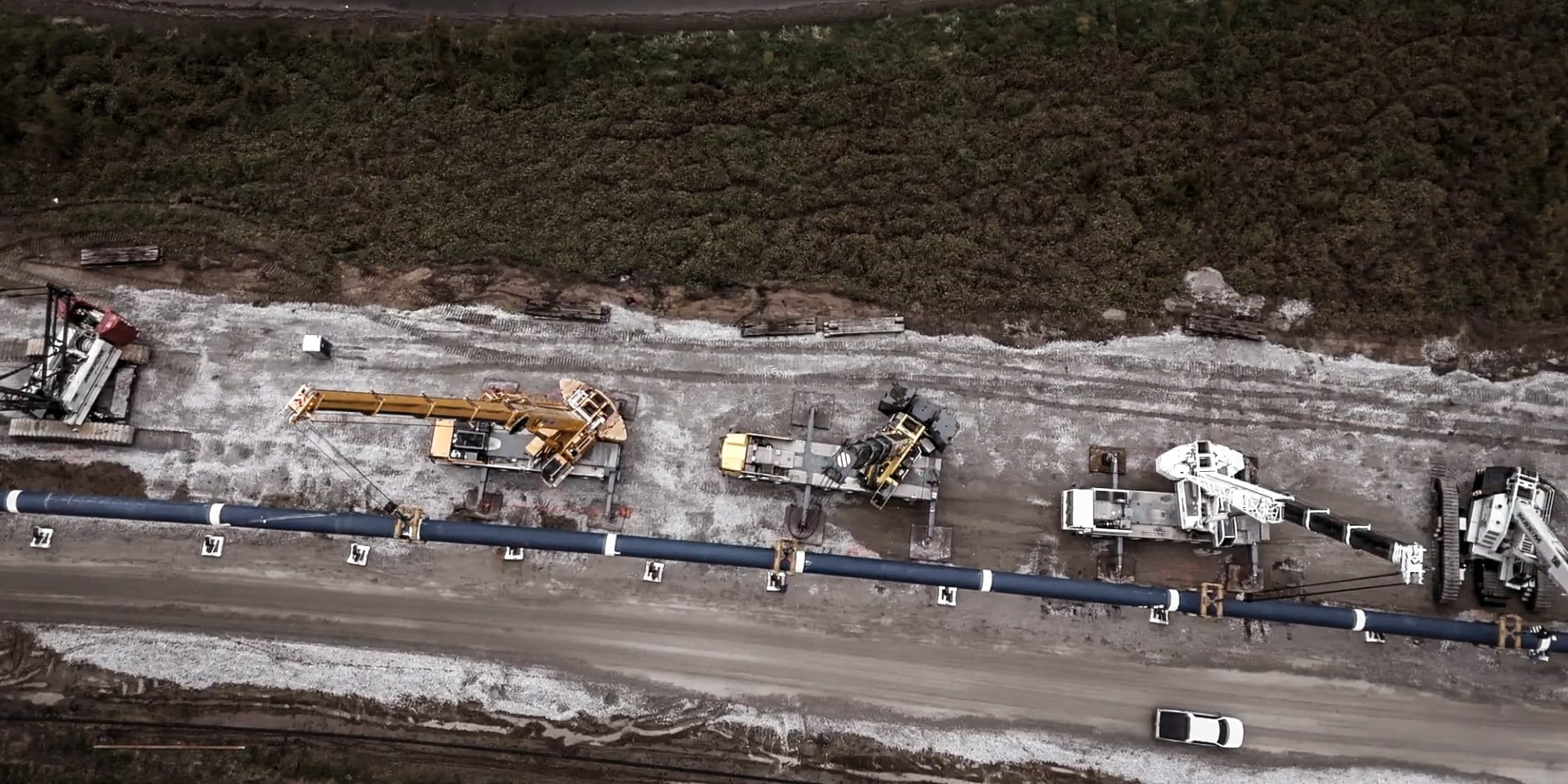 Aerial view of heavy machinery laying pipeline along the Platte River.