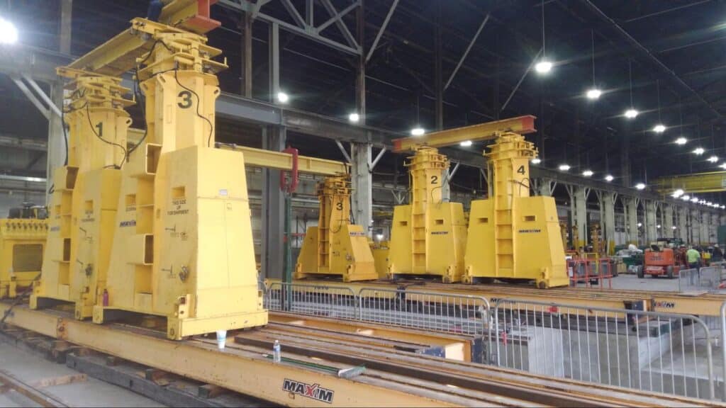 Cranes efficiently lifting heavy materials in a manufacturing facility.