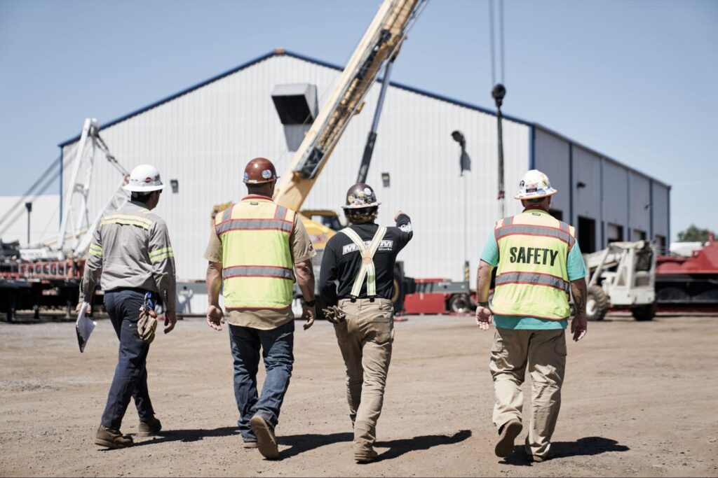 Construction workers prioritize safety while approaching a building site.
