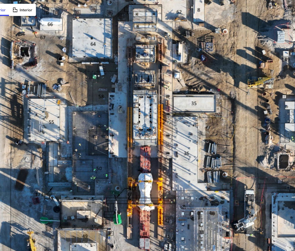 Aerial view of a busy construction site with machinery and workers present.