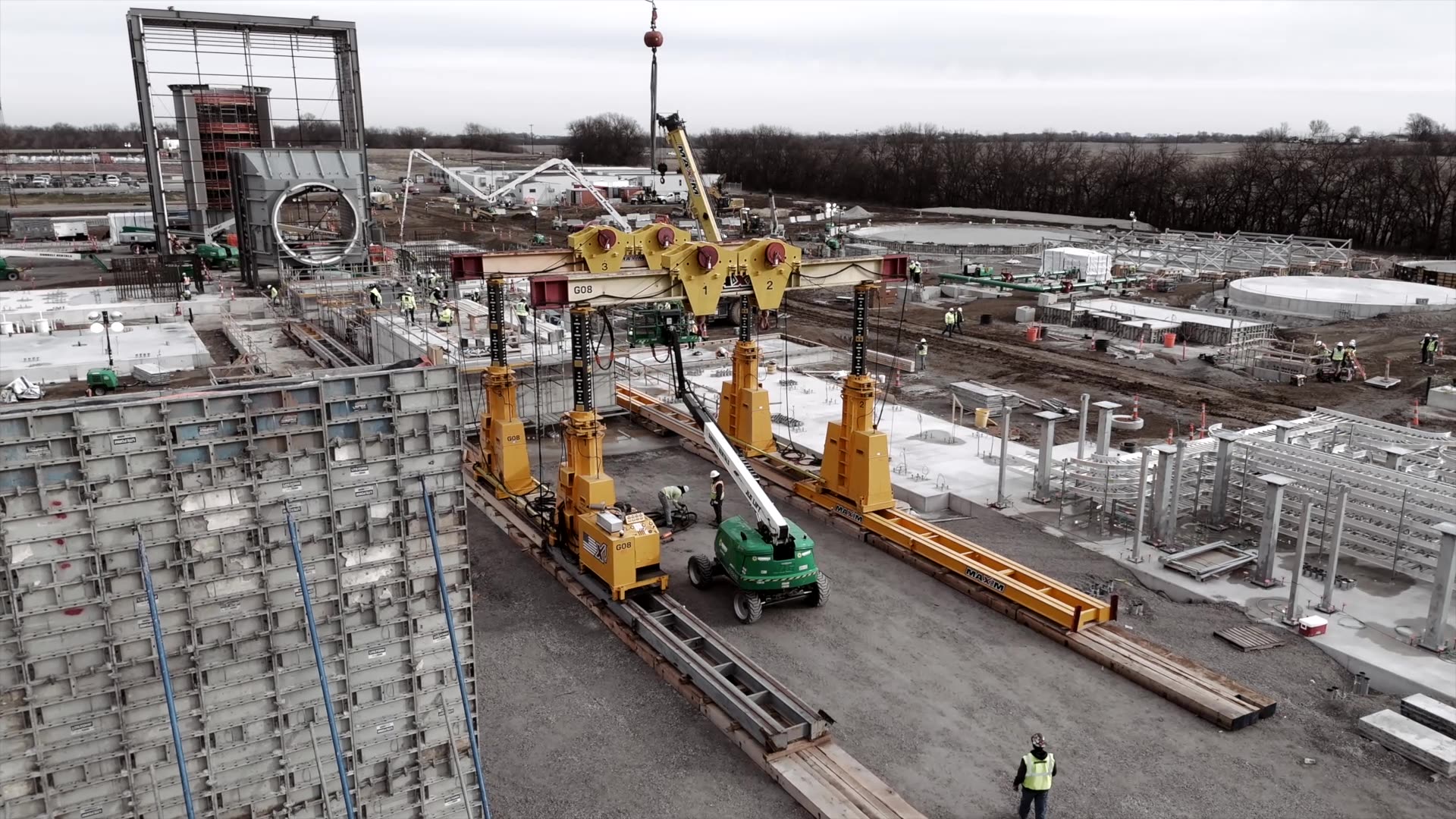 Construction site overview showcasing cranes, workers, and machinery in action.