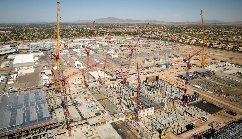 Aerial view of a large construction site with cranes and ongoing building projects.