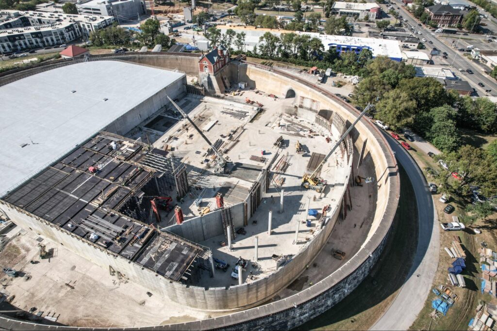 Aerial view of a construction site with heavy machinery and building materials.